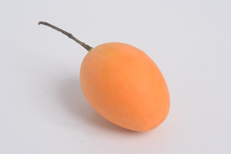 Sweet Marian plum or Plango  in a wicker basket. Yellow-orange color tropical fruits. Thai fruits