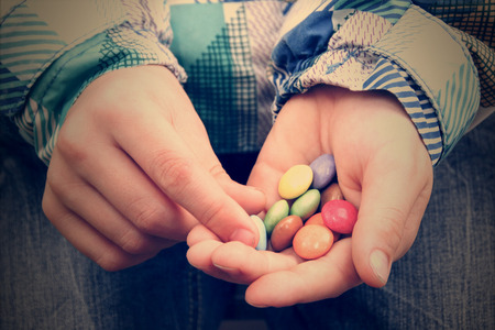 Pills in kid hands.の写真素材