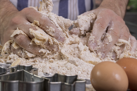 men's hands knead the doughの写真素材