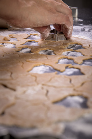 Making cookies on kitchen table, Roll out the dough and mold to cut, Selective focusの写真素材