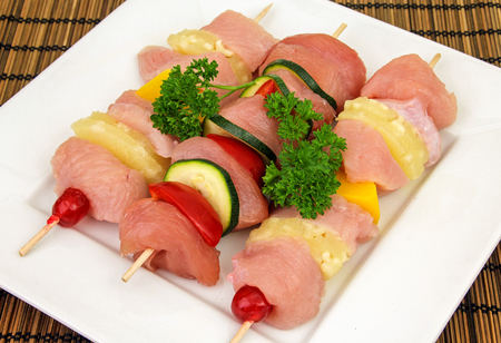 skewers of raw meat and vegetables の写真素材