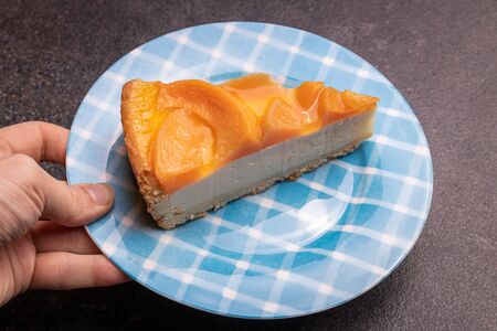 Peach creramy cake topped with jelly, peace of peach cake closeupの写真素材