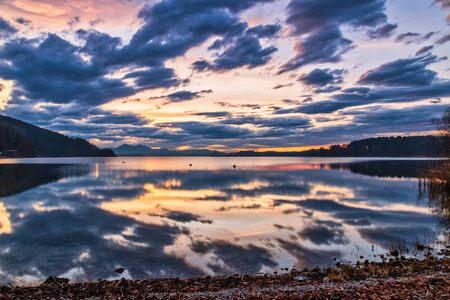 Beautiful scenery sunset sky view of lake and reflection in water, Wallersee, Austriaの写真素材