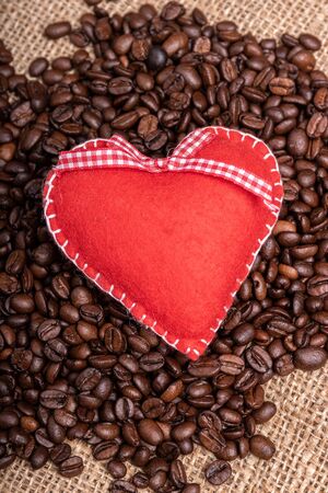 coffeebeans and a red felt heartの写真素材