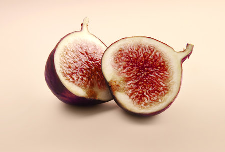 Tropical ripe purple fig fruit on beige backgroundの写真素材