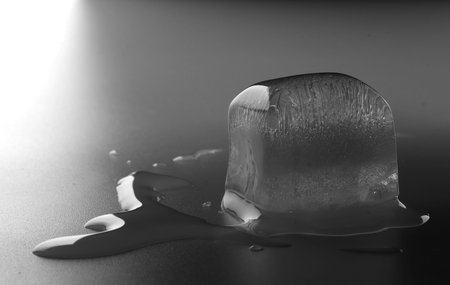 Ice cube on black background. low key photo. close up