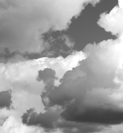 The sky is filled with dense, swirling gray clouds, hinting at an impending storm. The dynamic...