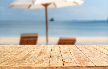 Mockup Empty Wooden Deck Table With Foliage beach Bokeh Background. wood table in front can be used for display or montage your products.Mock up for display of productの写真素材
