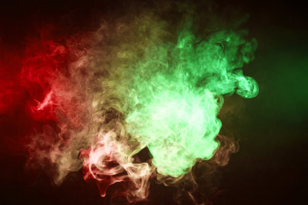 Background from pink and  blue  smoke of vape on black isolatedの写真素材