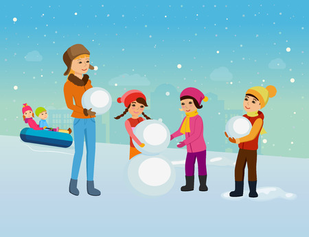 Young children in winter clothes, sculpt snowman in good mood.の写真素材