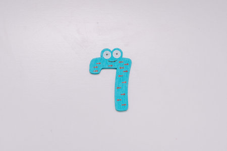 The number 7 in a cute children's number typeface is placed on a white base