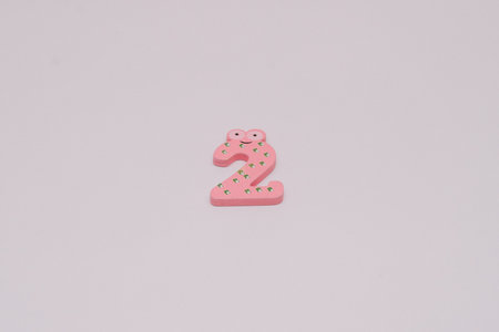The number 2 in a cute children's number typeface is placed on a white base