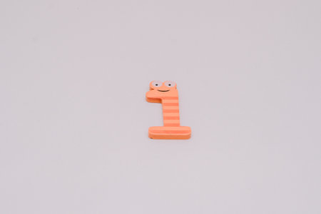 The number 1 in a cute children's number typeface is placed on a white baseの写真素材