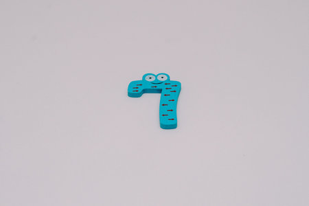 The number 7 in a cute children's number typeface is placed on a white base