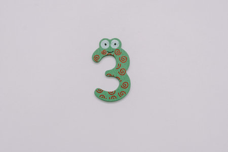 The number 3 in a cute children's number typeface is placed on a white base