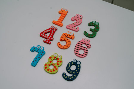 the numbers in a cute children's number typeface is placed on a white base