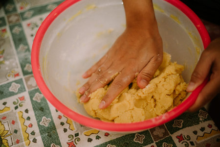 Mixing butter, eggs, wheat flour and sugar flour. This dough is ready to be made into Eid cakes.
