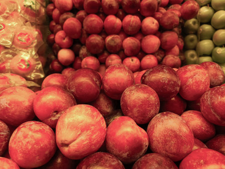 Apples showcased in a fruit shop display, presenting their crisp texture and vibrant colors, inviting customers with their freshness and appealの写真素材