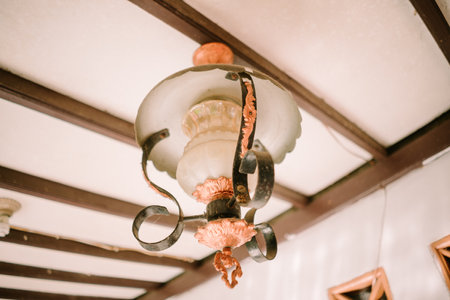 Classic vintage pendant lamp illuminates the sceneの写真素材