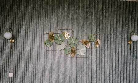 A striped pattern wall adorned with artificial flowers, adding a touch of elegance and colorの写真素材