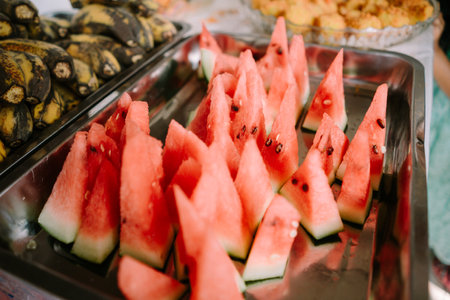 Chopped watermelon served on a tray, ready to eatの写真素材
