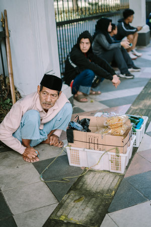 A street vendor selling tape ketan (fermented glutinous rice) by the roadside