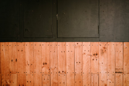 Gradient of black and brown, with black representing a wall and brown showcasing wooden elements of a building. Ideal for themes of architecture, texture, and interior design contrastの写真素材