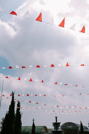 Street decorations featuring red and white paper streamers hanging from strings across the sky, creating a festive atmosphereの写真素材