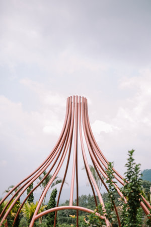 A decorative iron cone-shaped structure used to adorn plants, adding an elegant touch to the garden or outdoor space.の写真素材