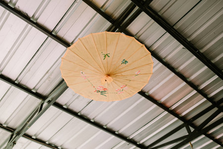 Decorative umbrella turned inside out and hung as a wall display. Perfect for themes of unique decor, creativity, and artistic home designの写真素材