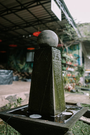 Mini waterfall garden decoration flowing gently, surrounded by lush greenery. Perfect for themes of relaxation, garden aesthetics, and tranquil outdoor spacesの写真素材