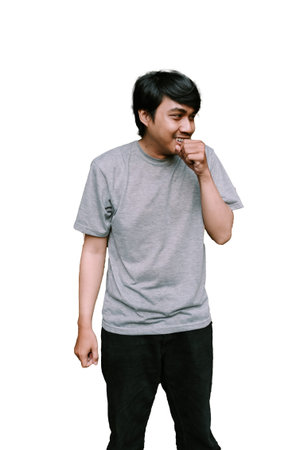 Southeast Asian man coughing, showing a concerned expression. Ideal for themes of health, illness,...