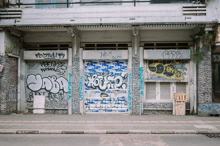 Vandalism artwork spray-painted on a residential house wall, displaying bold, unauthorized graffiti. Ideal for themes of street art, urban culture, and property defacementの写真素材