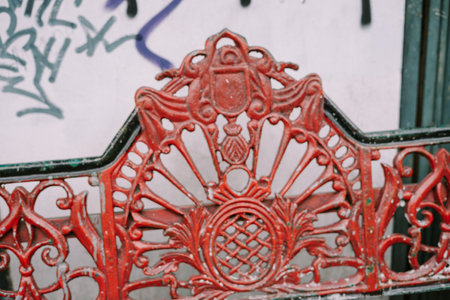 A public bench placed on the sidewalk as a resting spot for pedestrians. Perfect for themes of urban infrastructure, public amenities, and outdoor seating.の写真素材
