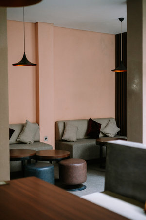 Modern lounge with soft pink walls, comfortable seating, and simple decor.の写真素材