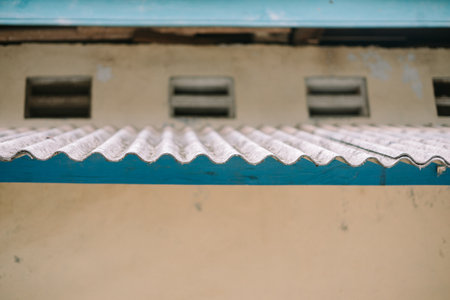Weathered awning with blue trim on a traditional house.の写真素材