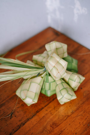 Ketupat is a dumpling made from rice packed inside a woven palm leaf pouch. It is a Southeast Asian specialty often served during festive occasions such as Eid al-Fitr. Commonly found in Indonesia, Malaysia, Brunei, Singapore and Philippines.の写真素材