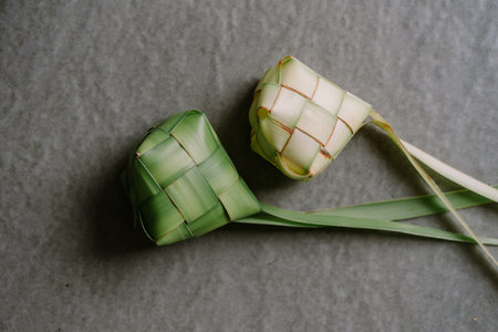 A close-up of ketupat, traditional rice dumplings skillfully woven from young palm leaves. Symbolizing celebration and cultural heritage, these culinary delights are often enjoyed during festive occasions and celebrations.の写真素材