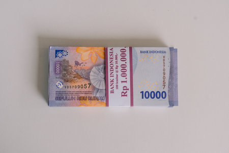 A stack of Indonesian Rupiah banknotes, depicting economic investment and finance. Representing currency, wealth, and the Indonesian economy, it signifies savings, capital, and financial abundance.の写真素材