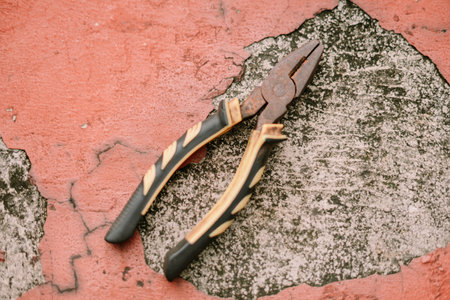 Rusty pliers lying on a weathered concrete. Old instrument for fixingの写真素材