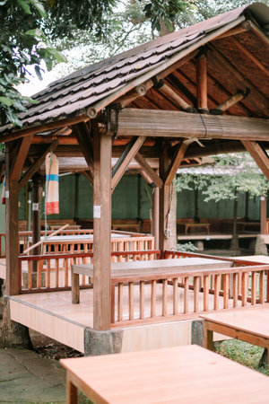 Picturesque wooden gazebo set in a peaceful outdoor space. A serene and inviting structure for relaxation and escape. Perfect for tourism and leisurely vacations.の写真素材