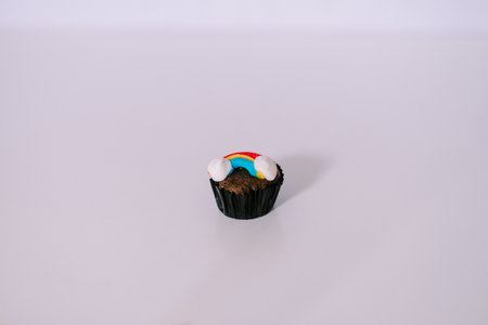 A fun cupcake decorated with a colorful rainbow frosting, perfect for a delightful treat or celebration.の写真素材