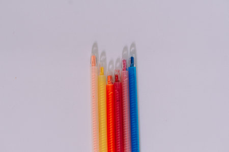 Close up of assorted color wax crayons on a white background. Ready to go back to school.