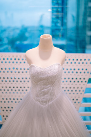 A beautiful wedding gown sparkles on a mannequin, ready for a memorable celebration of love and commitmentの写真素材