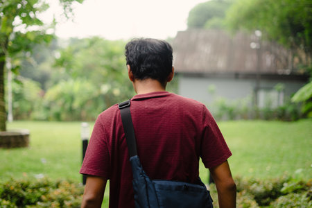A man has just arrived at a beautiful villa with a cool breeze and cozy ambiance, ready to relax and enjoy the peaceful surroundings.の写真素材