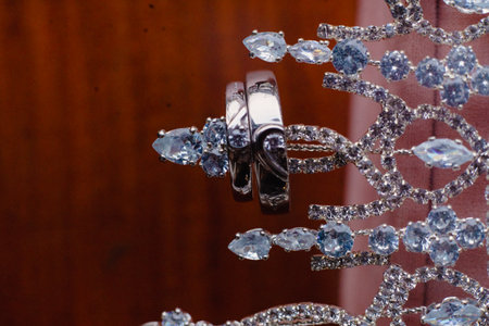 Close-up shot of wedding rings and elaborate jewelry. Displaying two rings, aquamarine gems and intricate designs, creates a sense of celebration, love, and the promise of forever in a romantic andの写真素材