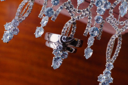 Stunning close-up of wedding rings adorned with a sparkling crystal necklace, symbolizing enduring love and the beauty of commitment, representing a joyous celebration of marriage and the beginningの写真素材