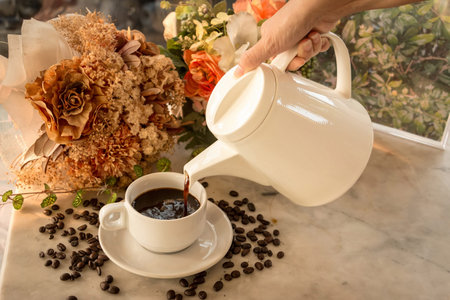 Hand Pouring coffee on marble tableの写真素材