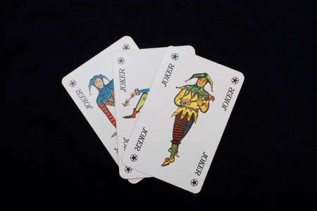 Three different jokers from a card game on a black background.のeditorial素材