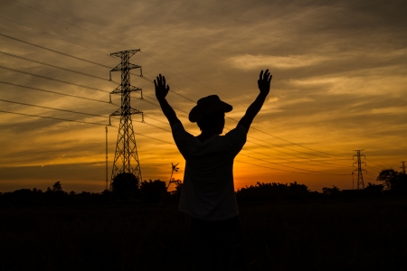 golden sky sunset with electric transmission tower and human shadowの写真素材